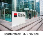 Small photo of PARIS, FRANCE - DEC 3, 2014: Businessman entering through the Societe Generale Headquarter entrance in La Defense. Societe Generale is the 7th largest bank in Europe (Q4 2015)