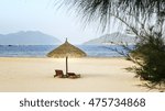 Small photo of Two lounge chairs with thatched umbrella on beach expressed desire to waiting couples resort, relaxing beautiful place in Vietnam seas