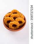 Small photo of Indian sweet jalebi or imarti or imarati, favorite pastry item in Kerala, India. Dewali sweet, fried crispy dessert. yellow, brown, orange jalebis. asian sweet