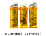 Small photo of Prescription drug bottles with twenty dollar bills inside, isolated on white