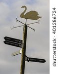 Small photo of CAELAVEROCK NATURE RESERVE, DUMFRIES & GALLOWAY, SCOTLAND - MARCH 22, 2016: MUTE SWAN WEATHER VANE AND MIGRATION DISTANCE INDICATOR SET AGAINST A BLANK CLOUDY SKY.