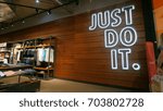 Small photo of BERLIN, GERMANY - CIRCA JULY, 2017: JUST DO IT sign inside Nike shop. Nike is one of the world's largest suppliers of athletic shoes and apparel. The company was founded on January 25, 1964.