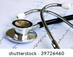 A stethoscope on the top of the EKG chart - stock photo