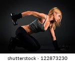 Fit woman exercising with weights - stock photo