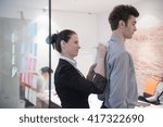 Small photo of signing contract on partners back, young couple on business meeting with life insurance and bank loan agent at modern office interior