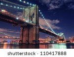 stock-photo-brooklyn-bridge-closeup-over-east-river-at-night-in-new-york-city-manhattan-with-lights-and-110417888.jpg