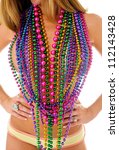 Small photo of Multi colored mardi gras beads over a woman's chest