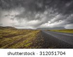 empty road with cloudy skies in ...