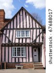 crooked timber framed house in...