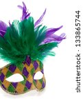 Small photo of A purple, gold and green Mardi gras mask with feathers on a white background