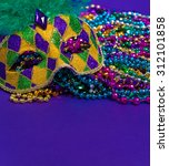 Small photo of Mardi Gras or carnival mask on bright purple background