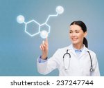 Small photo of healthcare, medicine and technology concept - smiling female doctor pointing to molecule of serotonin over blue background
