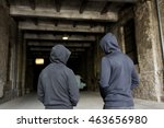 Small photo of criminal activity, addiction, people and social problem concept - close up of addict men or criminals in hoodies on street