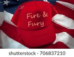 Small photo of Red trucker cap on the american flag with the words "fire and fury" written on it