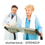 Senior lady walks on treadmill under the supervision of her doctor. Isolated on white. - stock photo