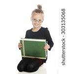 Small photo of An adorable elementary girl looking studiously at the viewer over her glasses. He holds a giant textbook on her lap. On a white background.