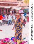 Small photo of JODHPUR, INDIA - MARCH 03, 2018: Unidentified woman sells Sari traditional costume at Sardar street market in Jodhpur.