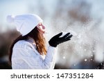girl playing with snow in park