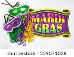 Small photo of Mardi Gras beads, masks and banner reading Mardi Gras in traditional festive colors on a white background in horizontal or landscape format