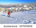 snow covered slope and woman...