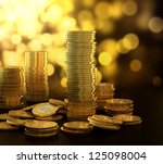 stock-photo--d-illustration-of-gold-coin-stack-on-blue-background-125098004.jpg