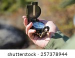 man using a magnetic compass to ...