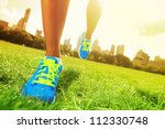 Runner - running shoes closeup of woman barefoot running shoes. Female jogging in Central Park, New York City. - stock photo