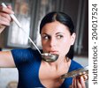 Young housewife cooks food in <b>kitchen. Soup</b>. Dinner. - stock-photo-young-housewife-cooks-food-in-kitchen-soup-dinner-photo-with-instagram-style-filters-photo-with-204017524