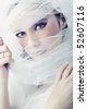 Young brunette beauty or bride, behind a white veil - stock photo