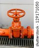 stock-photo-a-big-orange-color-water-supply-main-pipeline-with-a-stopcock-valve-against-a-concrete-wall-129171050.jpg