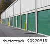 Row of outdoor green door self-storage units - stock photo