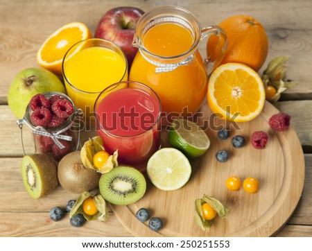 sweet juice and fruits on wood