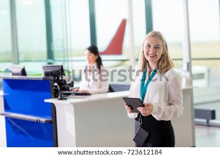 Young Ground Staff Holding Digital Tablet At Airport