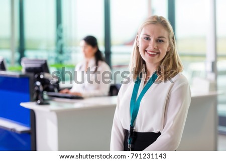 Young Ground Staff Smiling While Colleague Working At Airport Re
