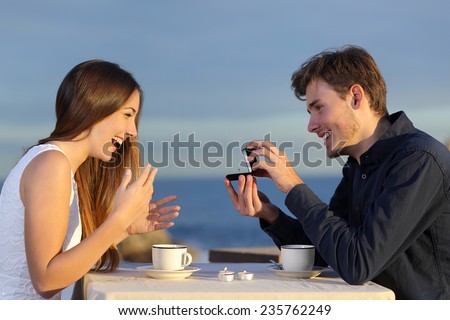 https://thumb1.shutterstock.com/display_pic_with_logo/1020994/235762249/stock-photo-boyfriend-requesting-hand-of-his-girlfriend-with-a-engagement-ring-in-a-restaurant-with-the-ocean-235762249.jpg
