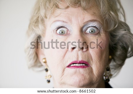 stock-photo-close-up-of-a-senior-woman-with-a-horrified-look-on-her-face-8661502.jpg