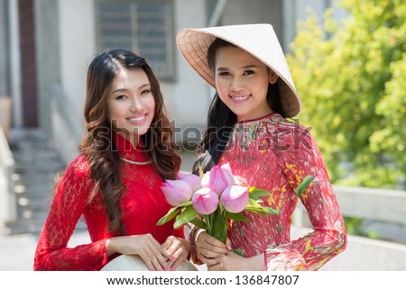 Young girls in traditional dresses posing for the camera
