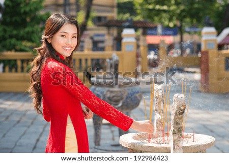 Vietnamese woman holding an incense stick