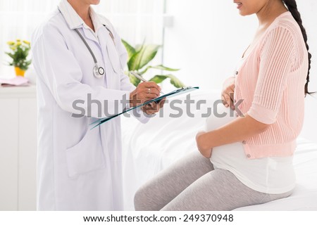 Cropped image of pregnant woman visiting doctor