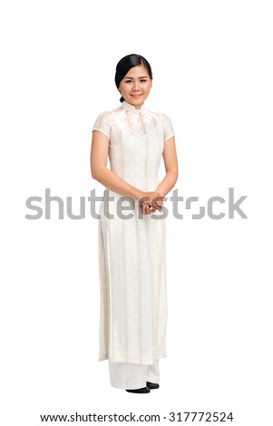 Full-length portrait of Vietnamese girl in ao-dai dress, isolated on white