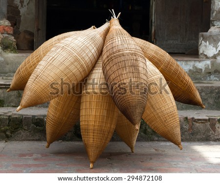 Weaving bamboo fish trap in HungYen, Vietnam. Weaving this tools that used to catch fish is traditional occupation in Hung Yen province.