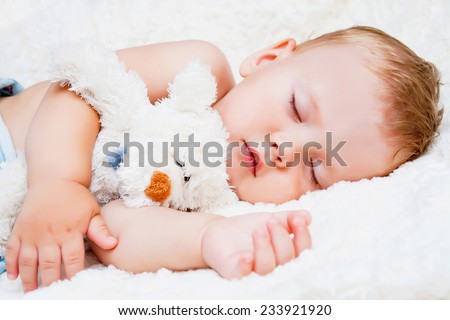 Cute sleeping child with teddy bear