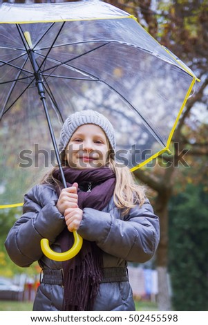Happy girl with umbrella in autumn
