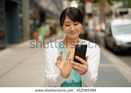 https://thumb1.shutterstock.com/display_pic_with_logo/1051921/452985484/stock-photo-young-asian-woman-walking-street-texting-cell-phone-452985484.jpg