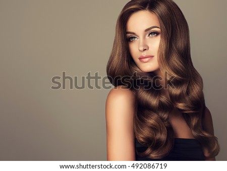 stock photo beautiful girl with long wavy and shiny hair brunette woman with curly hairstyle 492086719