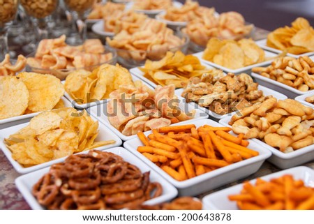 Many types of savoury snack in white dishes - stock photo