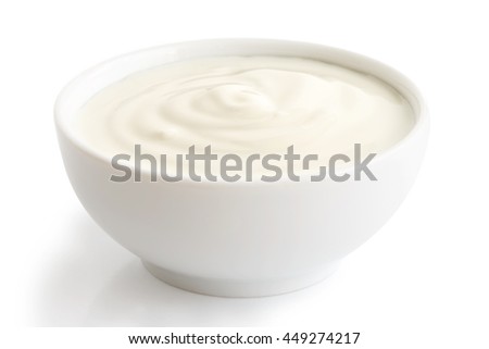 Ceramic bowl of white yogurt isolated on white background.