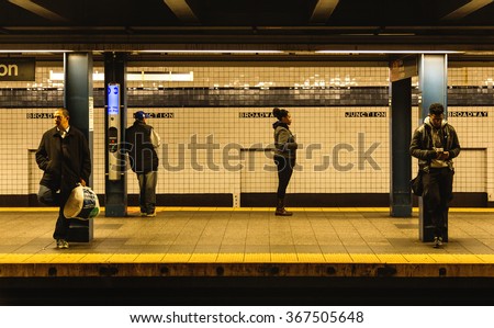 NEW YORK - December 21, 2015: Subway train Broadway station platform with people traveling in New York. The NYC Subway is a rapid transit/transportation system in the City of NY.