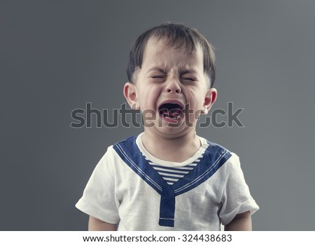 Angry little boys with sad expressions, screaming and crying