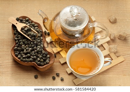 Green tea leaves / tea cup and tea cup / tea pouring